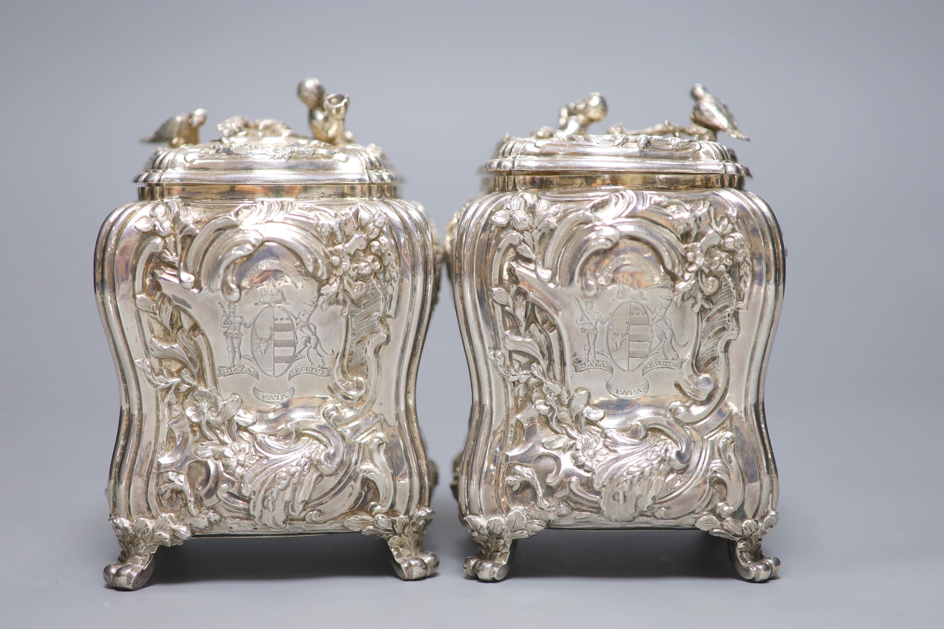 A good pair of George II embossed silver tea caddies and covers, by Elizabeth Godfrey, London, 1749/50, housed in a later 19th century pierced Canton ivory mounted caddy, with velvet interior